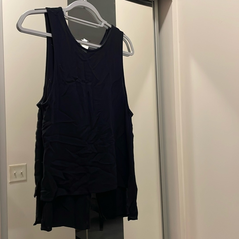 Black flowy shirt open in back. Size S.